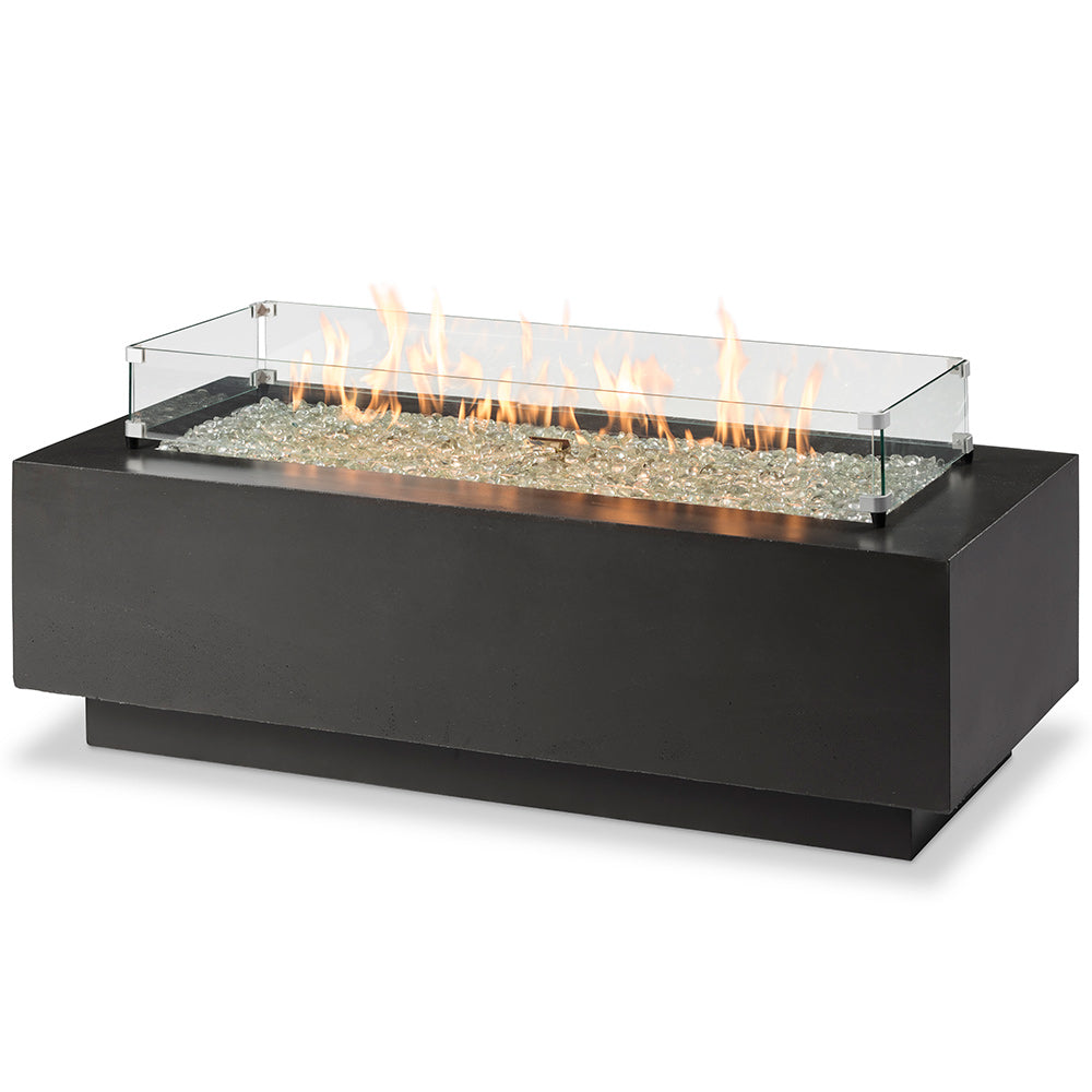 Linear gas fire pit table in black with glass wind guard and flames