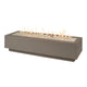 Linear gas fire pit table in earth stone with clear glass fire bed and steady flames