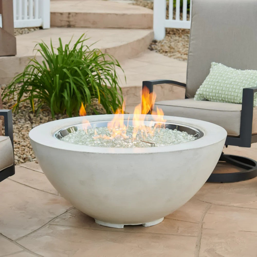 White gas fire pit bowl burning with flame over glass burner media