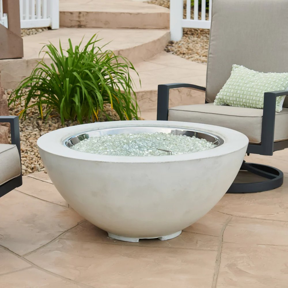 White gas fire pit bowl with clear glass burner media visible, no flames