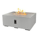 Light beige linear gas fire pit table with burner tray and control panel, flames on top