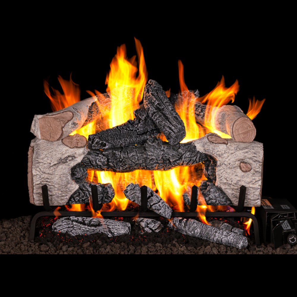 Vented gas log set with charred cinder birch logs and glowing flames on a metal grate