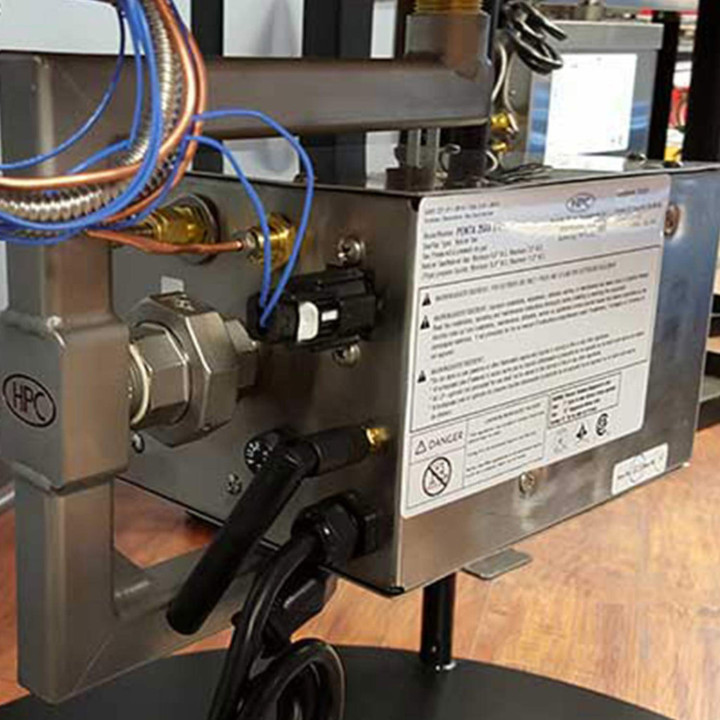 Stainless steel gas control unit with wiring, valves, and instruction label