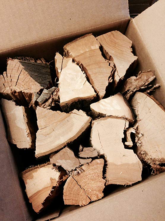 Oak wood chunks in a cardboard box, light brown broken pieces