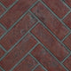 Decorative brick panel with red herringbone brick pattern and gray mortar
