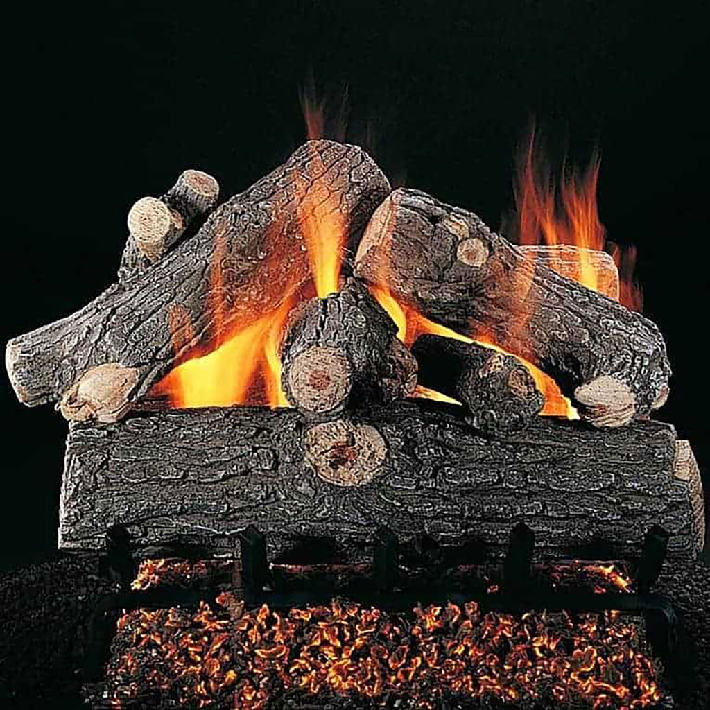 Gas fireplace logs with glowing orange flames on dark charcoal wood pieces
