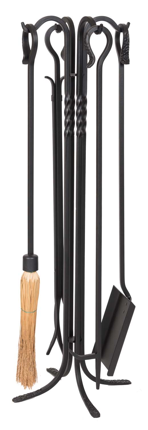 Black wrought iron fireplace tool set with brush, poker, shovel, and tongs on stand