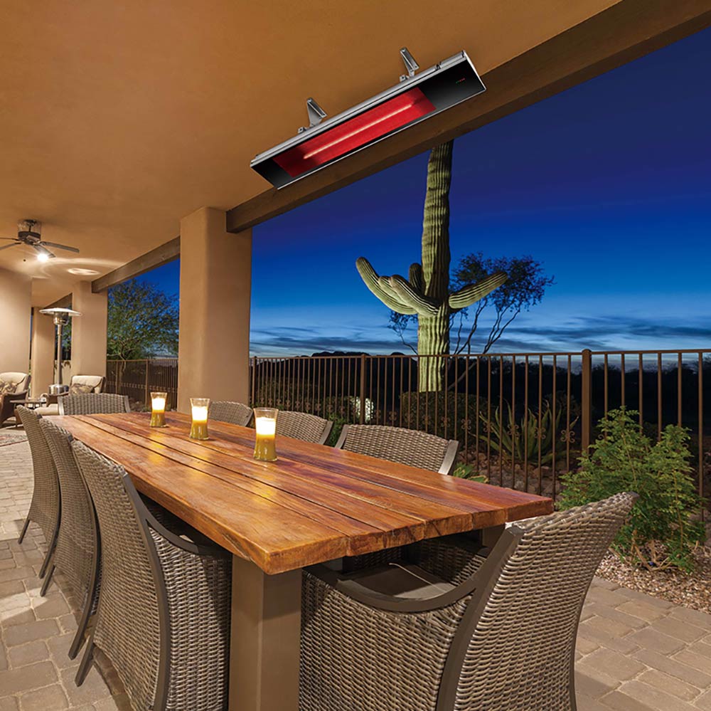 Ceiling-mounted infrared electric heater with red glow over outdoor dining table