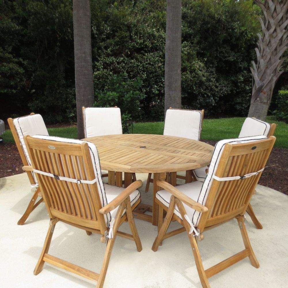 Teak round drop-leaf table with slatted top and four matching outdoor chairs