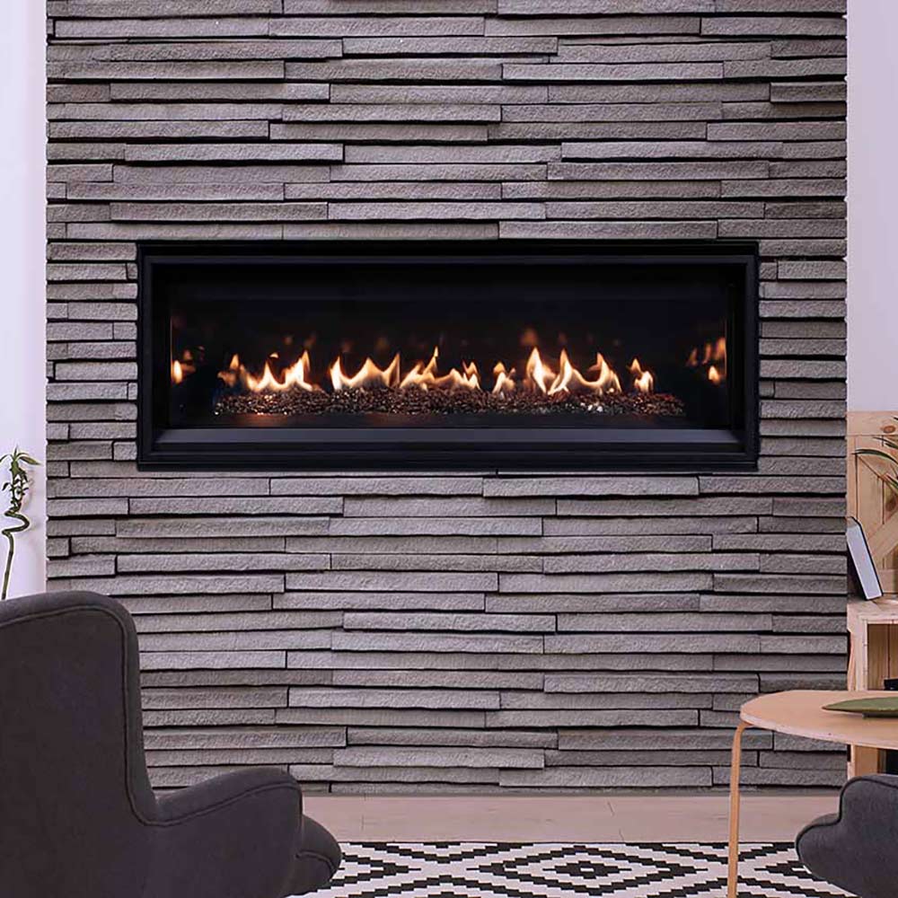 Direct vent gas fireplace in wall opening with flames over crushed glass media