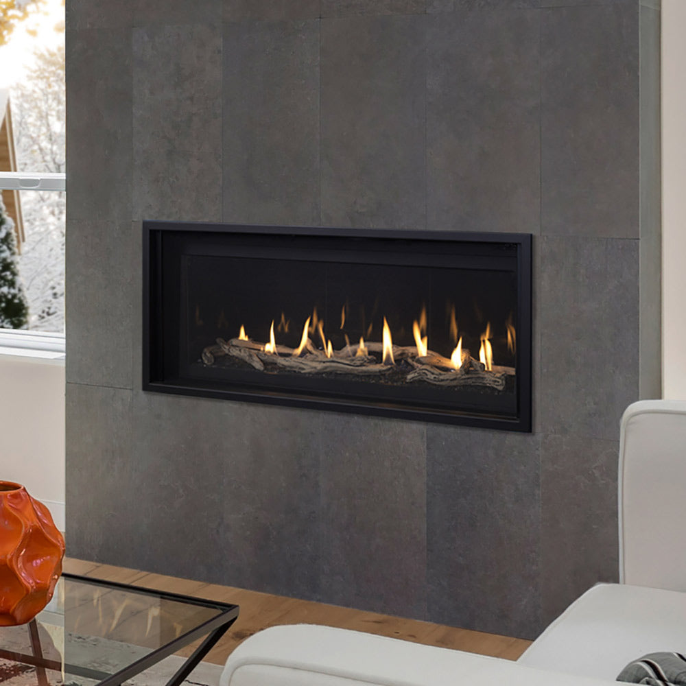 Recessed black linear gas fireplace with flames and decorative logs behind glass