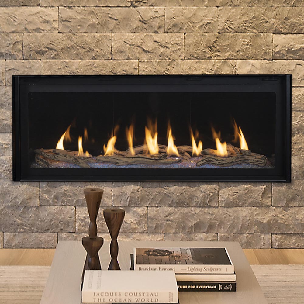 Linear gas fireplace with black frame and glowing flames over a log bed.