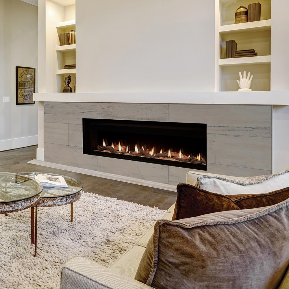 Built-in gas fireplace with flames behind black firebox and glass media