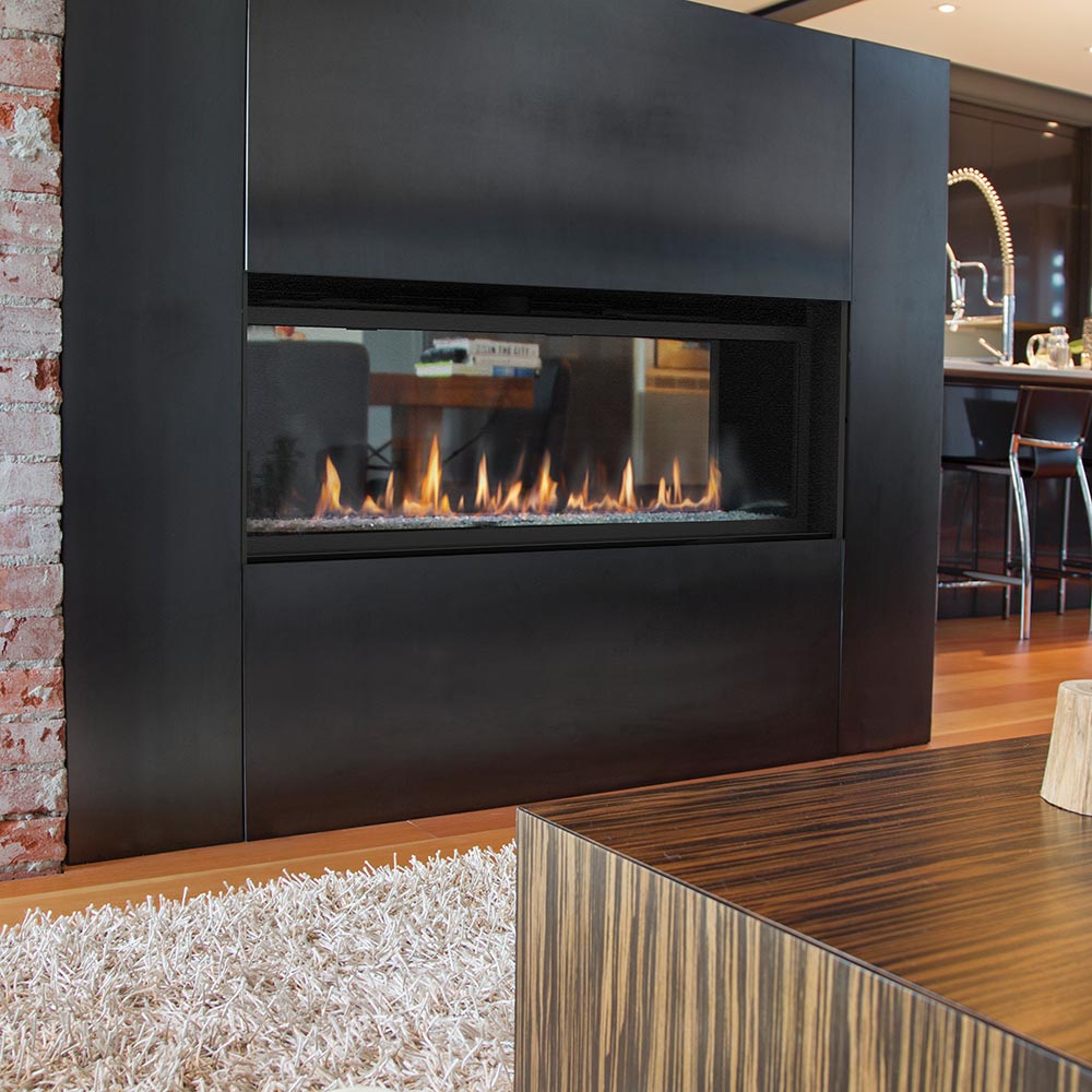 Dark see-through gas fireplace with inset glass window and flames