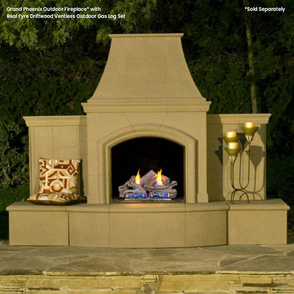 Outdoor ventless gas fireplace with driftwood-style logs and small flames in firebox