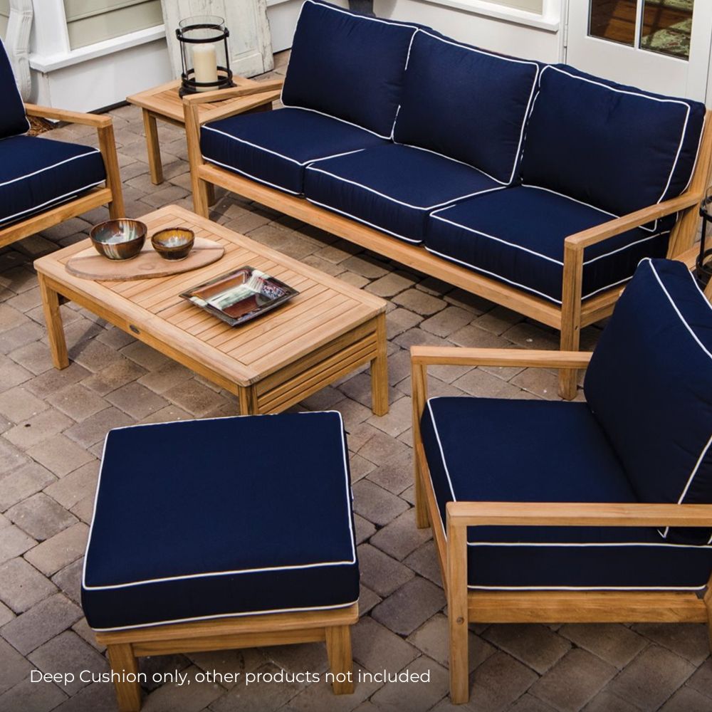 Square navy cushion with light piping, styled on outdoor wooden seating