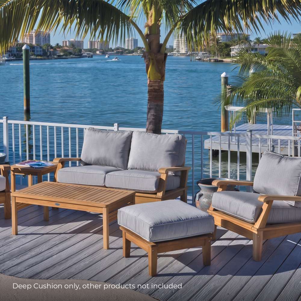 Square outdoor cushion with light gray fabric on wooden patio seating