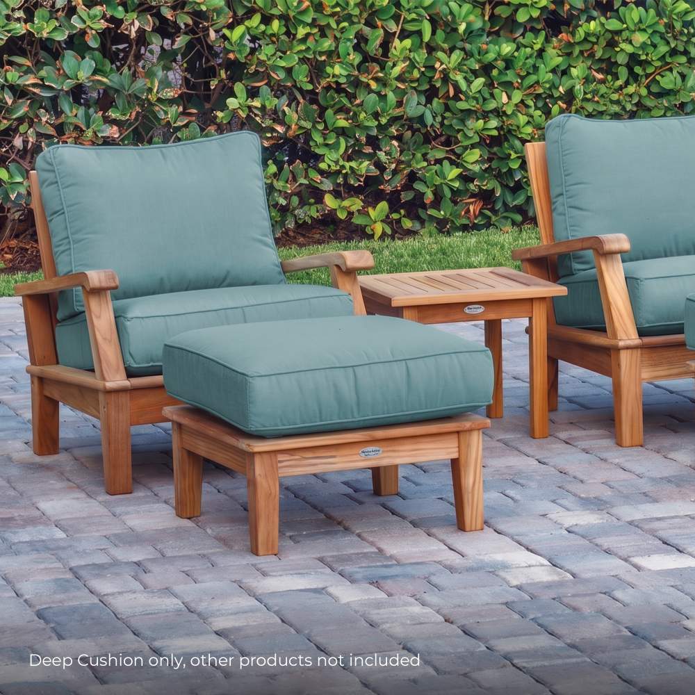 Square outdoor cushion in muted teal with neat stitched edges