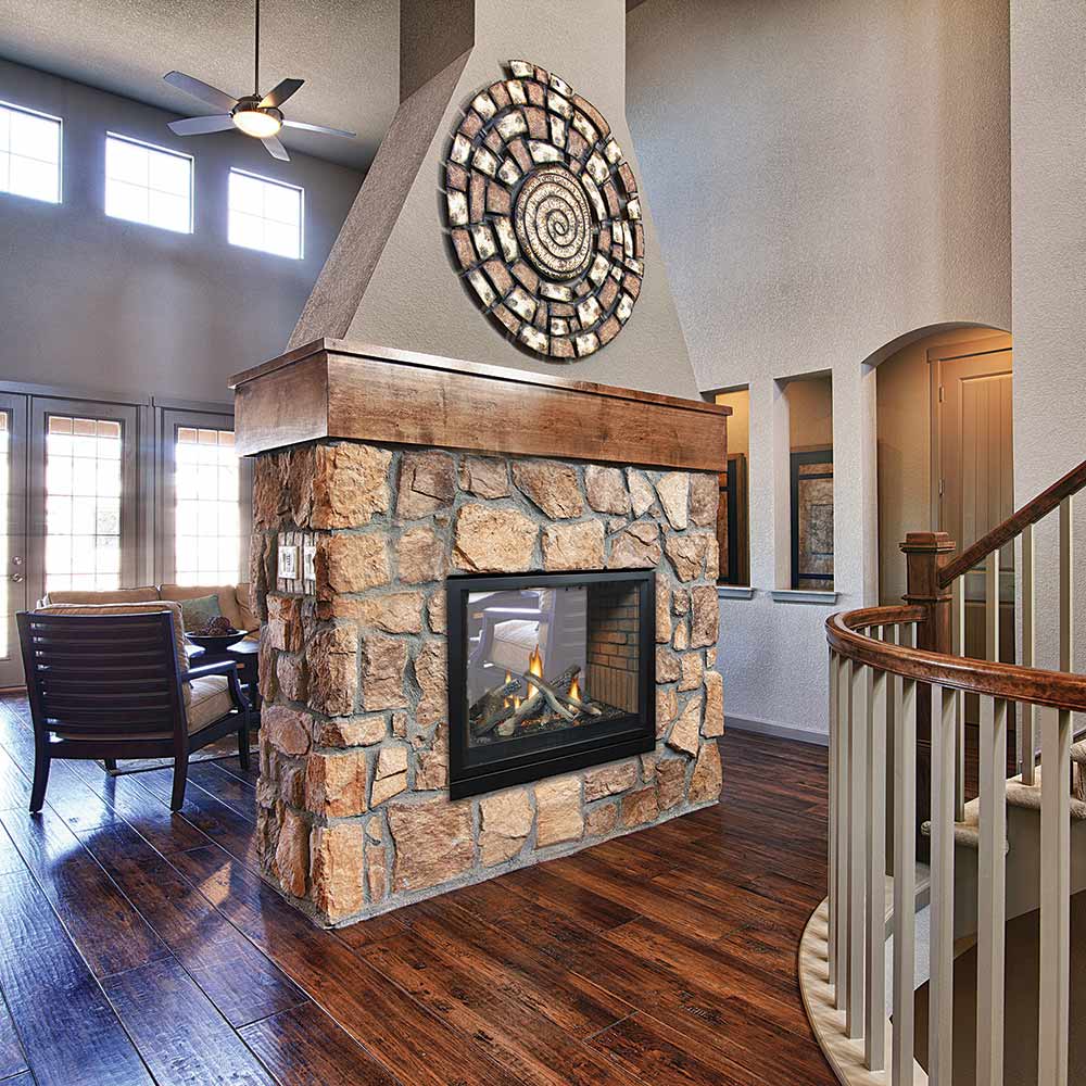 Direct vent see-through fireplace with black glass doors set in a stone wall surround