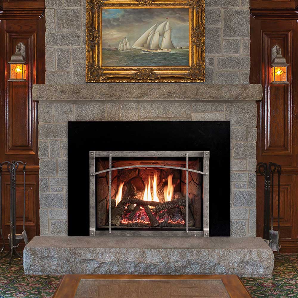 Direct vent gas fireplace insert with front glass and charred log set, burning flames