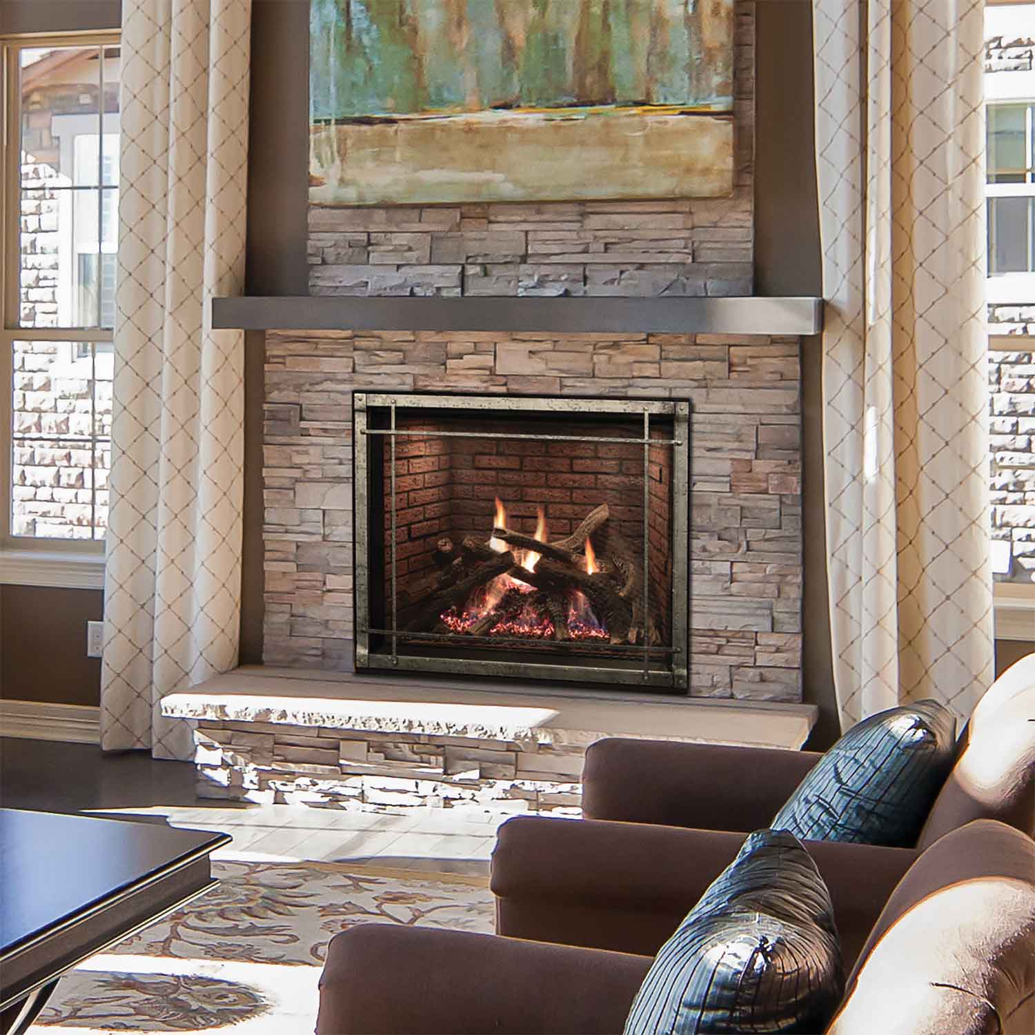 Stone-surround direct vent fireplace with burning logs visible in black metal frame
