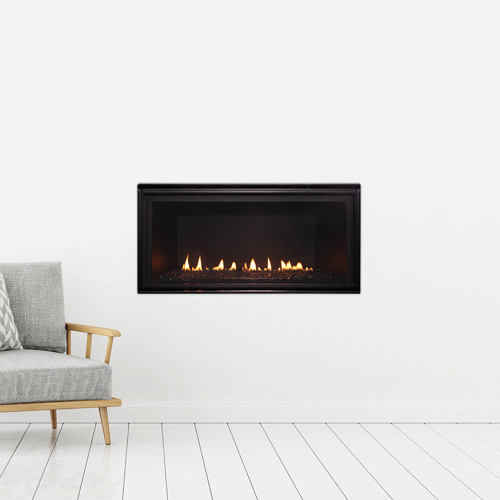 Wall-mounted linear gas fireplace with black trim and glass flame view