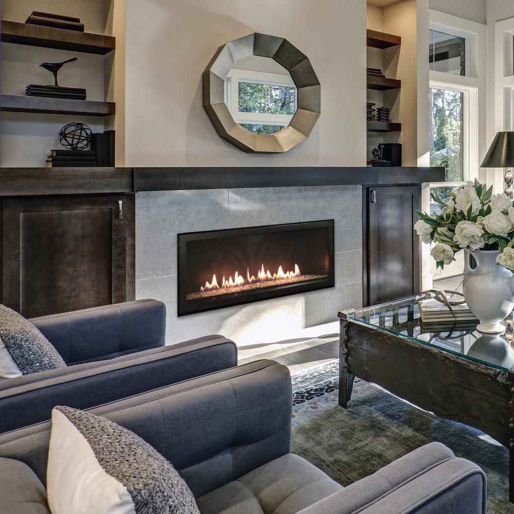 Linear direct vent gas fireplace with black surround and visible flames