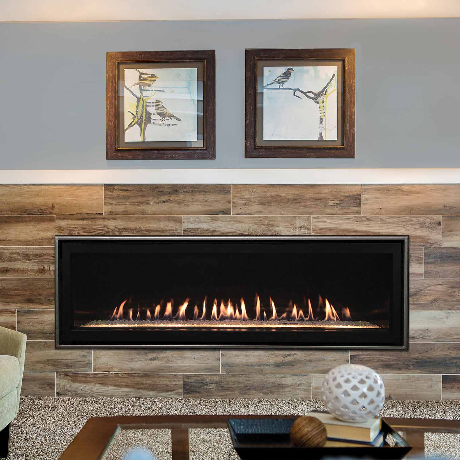 Linear direct vent fireplace with glowing flames in black opening