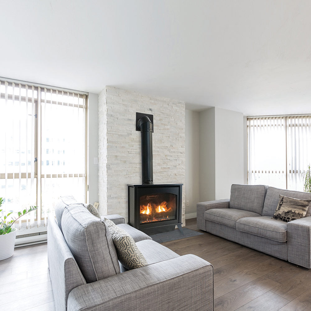 Black steel direct-vent stove with burning logs and vent flue