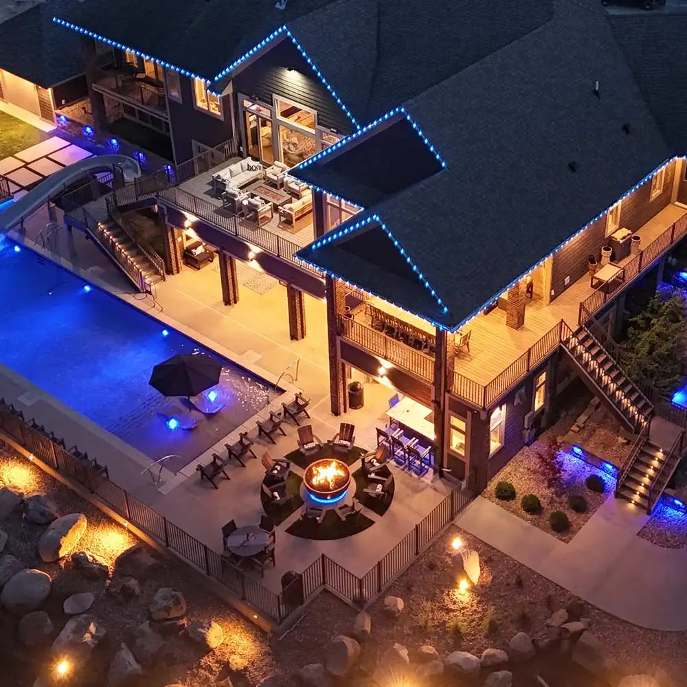 Aerial view of a luxurious house with a pool at night