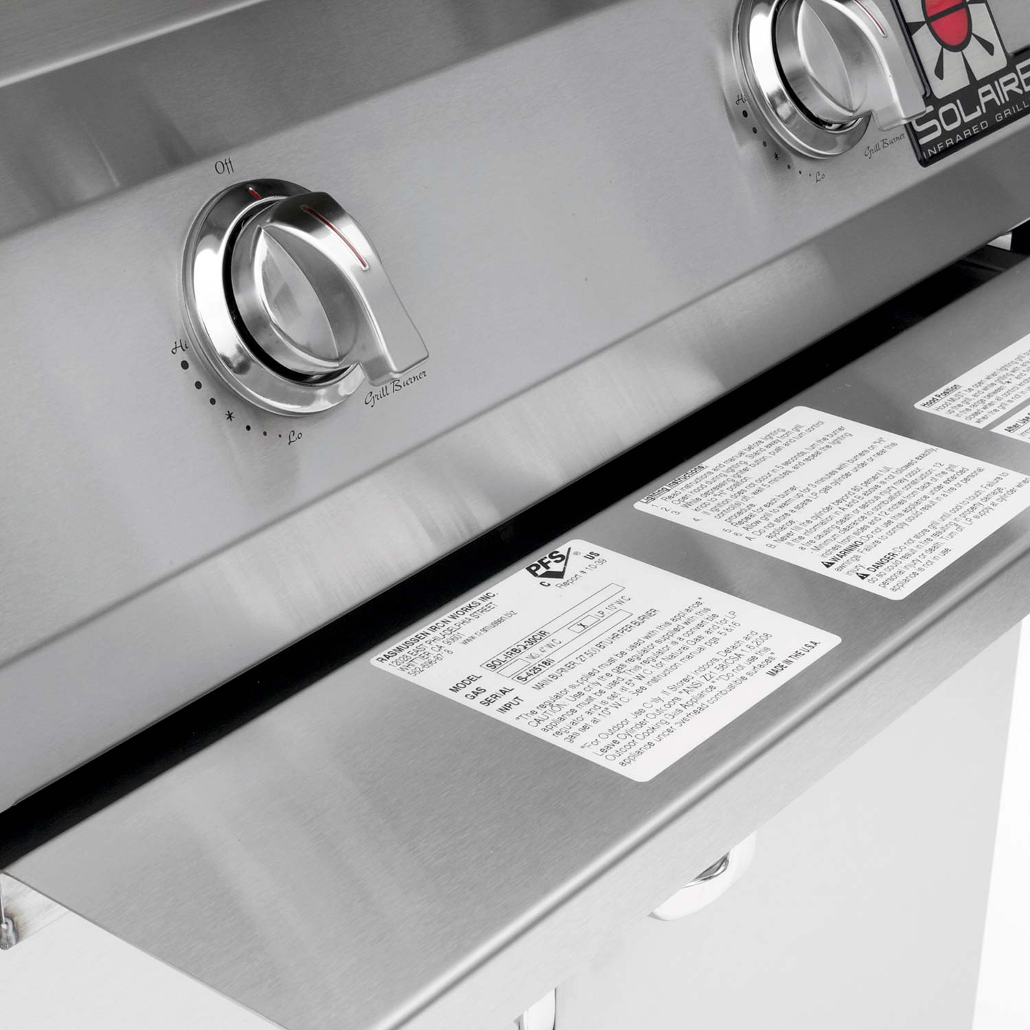 Stainless grill control area with burner knob and control panel labels