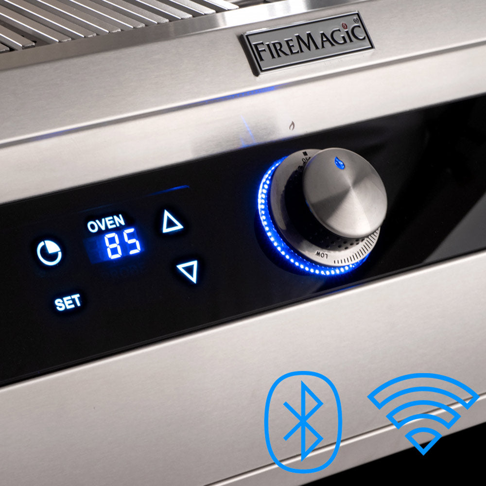 Gas grill control panel with FIREMAGIC label, blue LED display, and control knobs