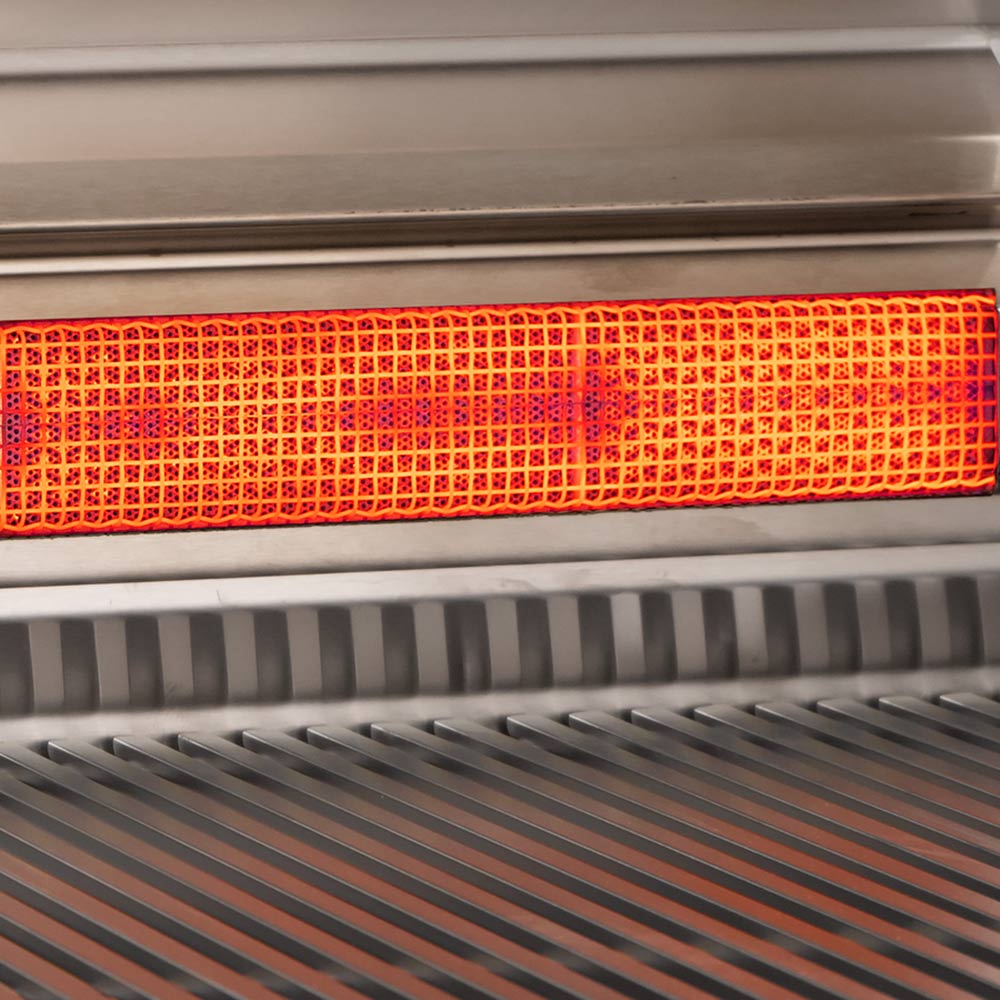 Orange glowing burner surface inside stainless gas grill