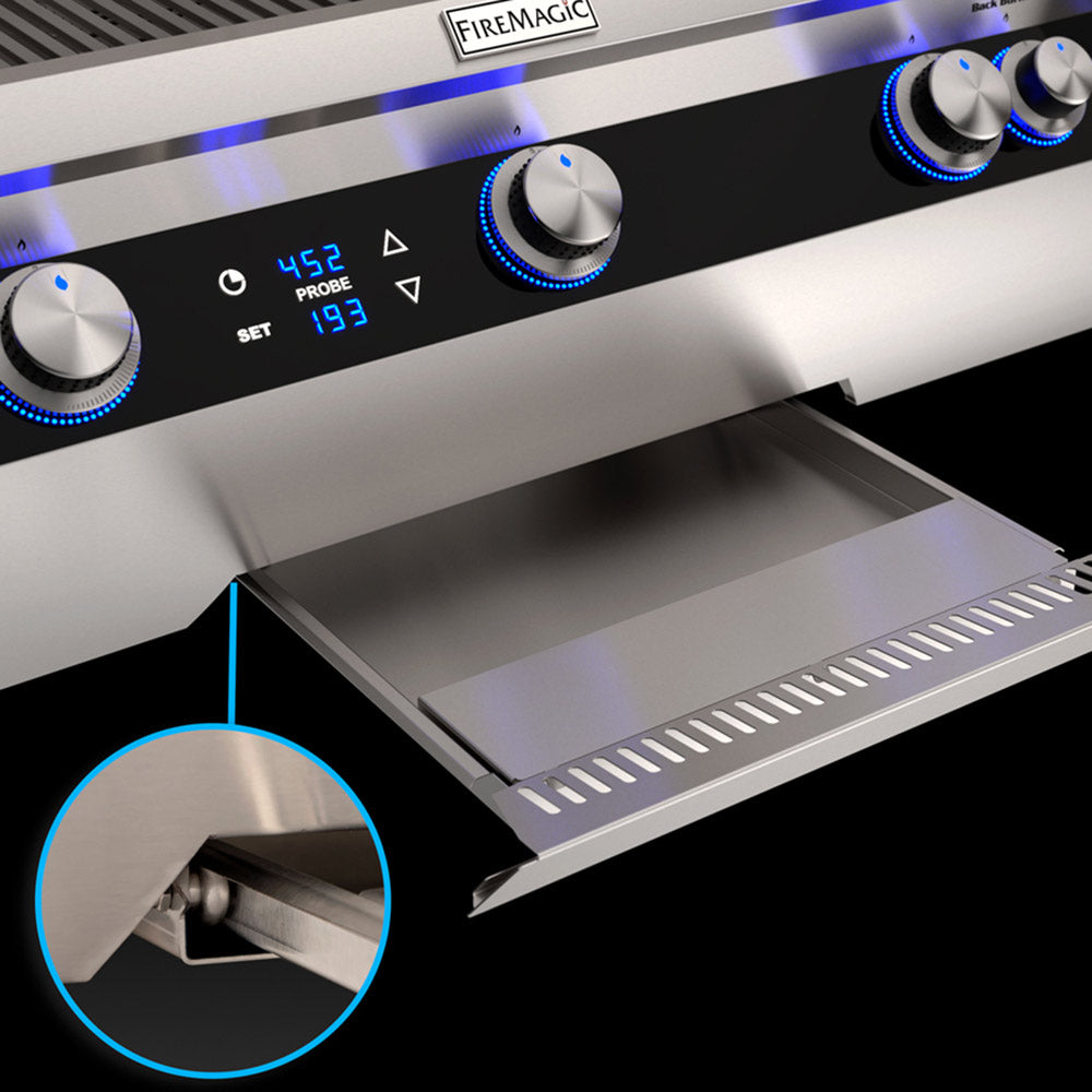 Outdoor grill control panel with FIREMAGIC badge, blue-lit knobs and display