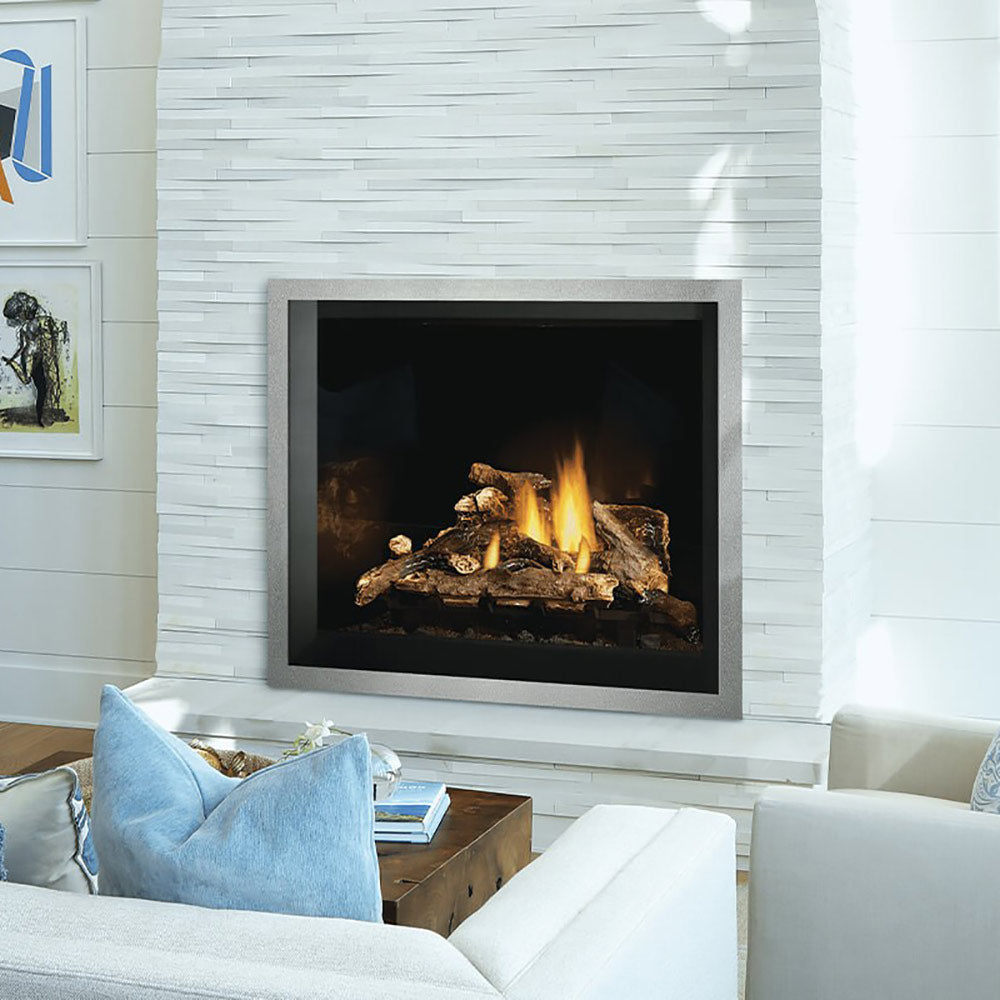 Direct vent gas fireplace with black firebox and burning logs on white brick wall