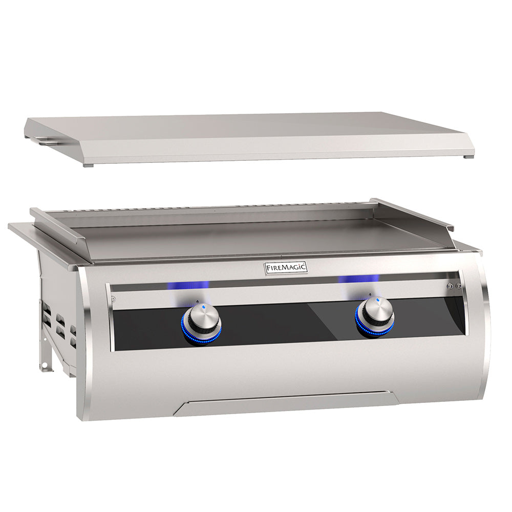Stainless built-in gas griddle with black glass control panel and two blue knob controls