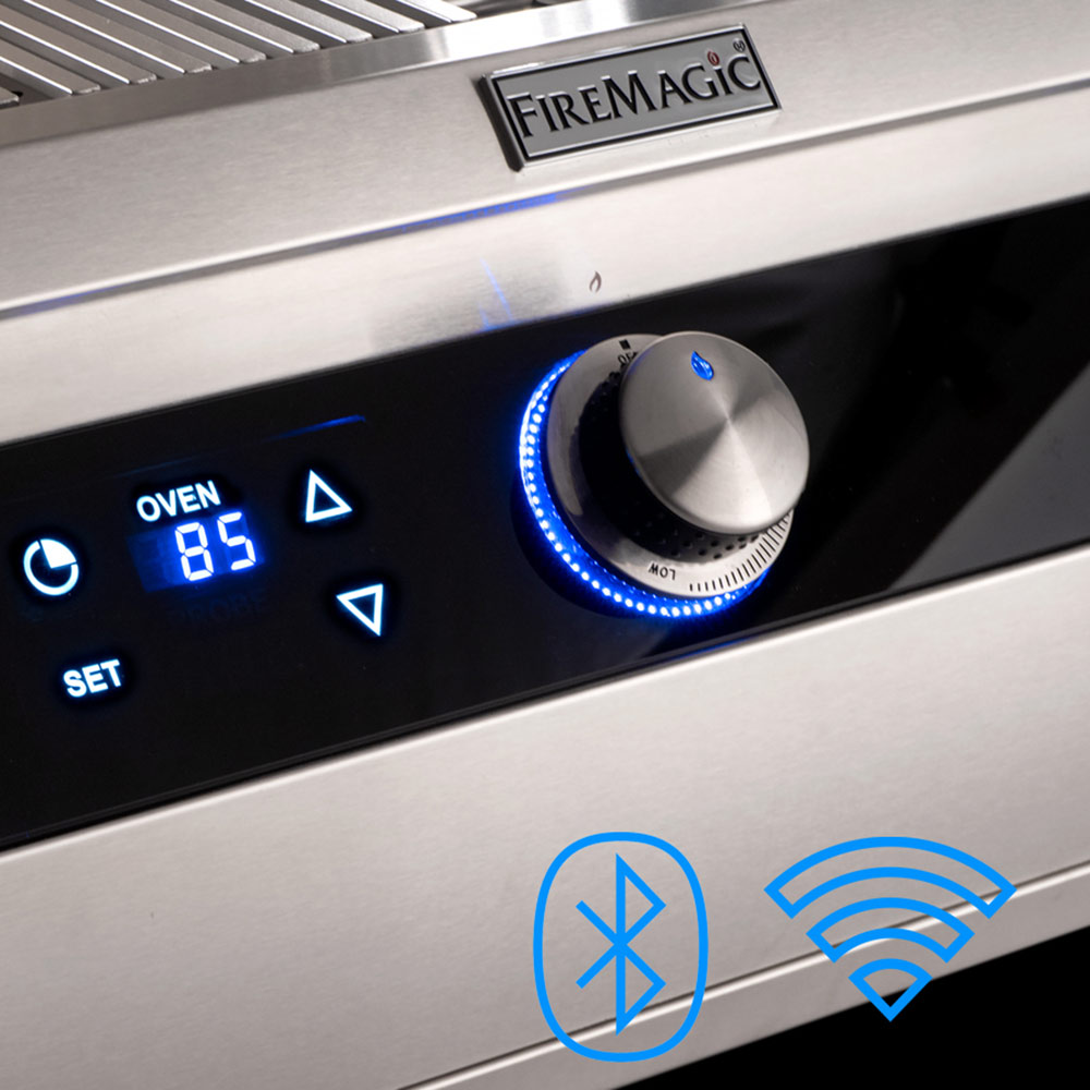 Gas grill control panel with blue-lit display, stainless knobs, and FireMagic logo