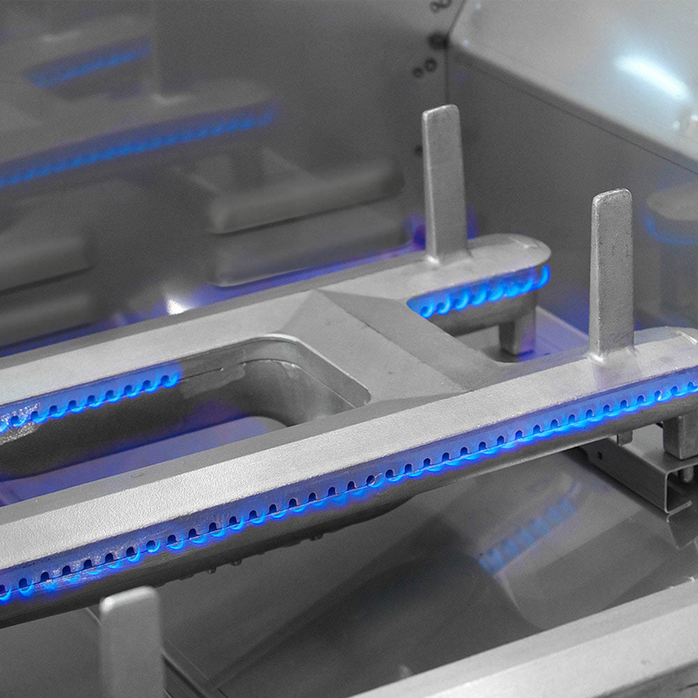Stainless steel burner with glowing blue ignition bars inside grill hood