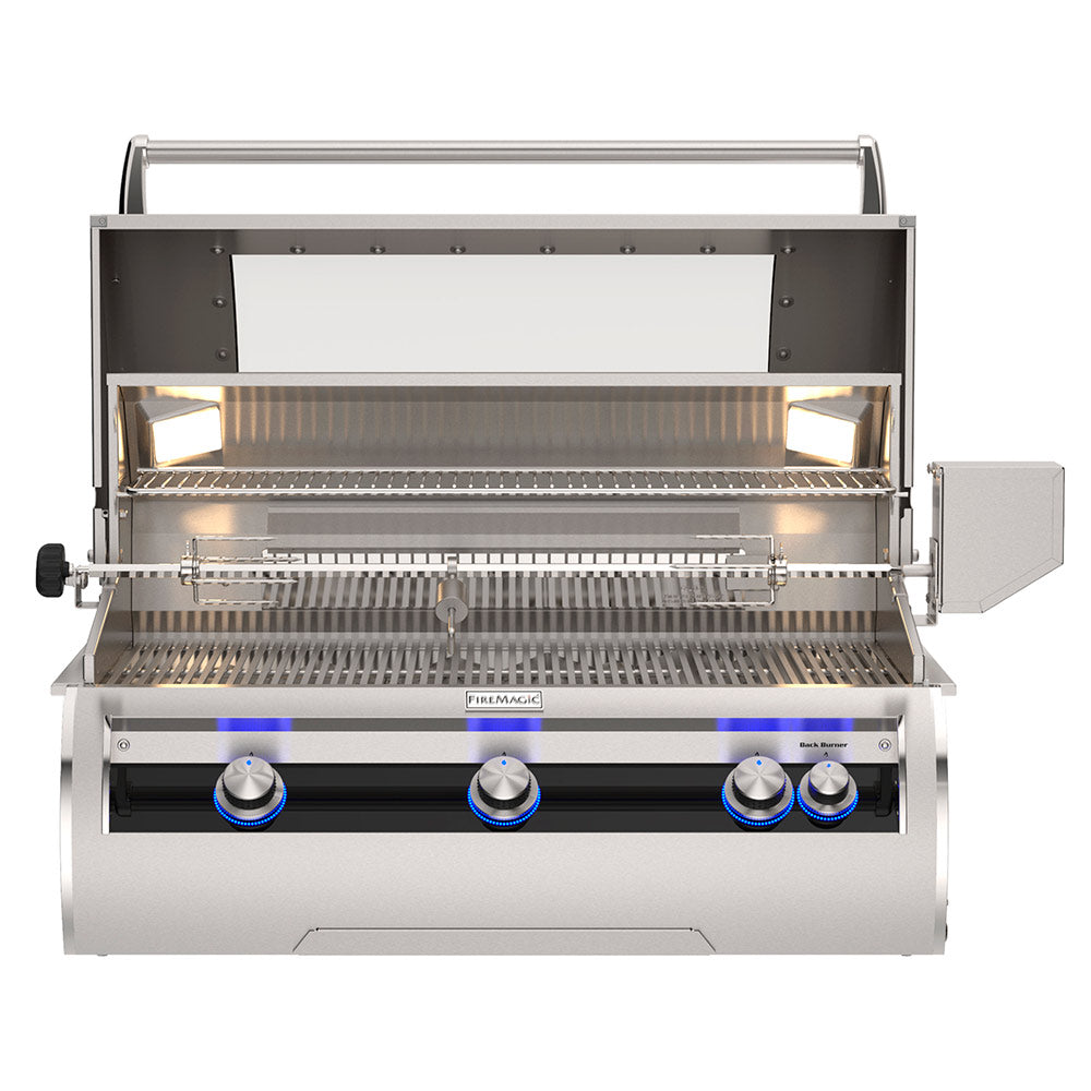Built-in gas grill with lid open, stainless cooking grates, and burner controls visible