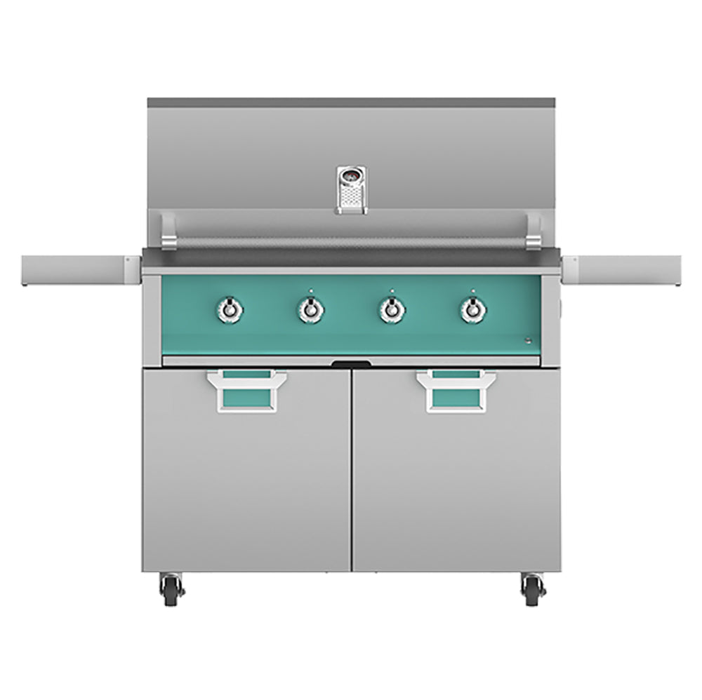 Freestanding gas grill with teal control panel, four knobs, side shelves, and two cabinet doors