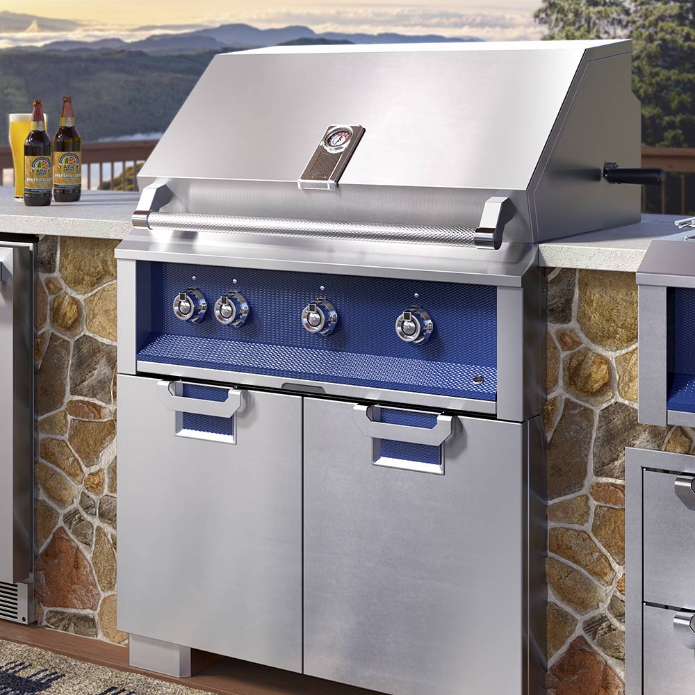Built-in gas grill with blue control panel and stainless cart-style base in outdoor kitchen