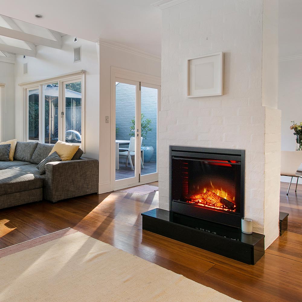 Freestanding electric fireplace with visible glowing logs and dark surround frame