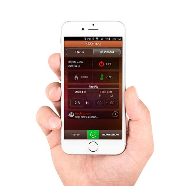 Hand holding smartphone displaying remote ignition app for outdoor fire burner