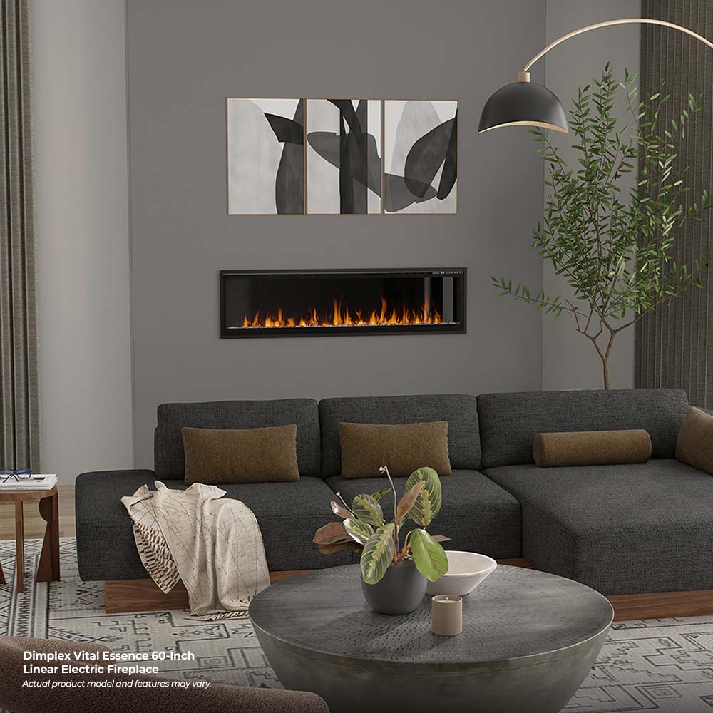 Slim wall-mounted electric fireplace with black frame and flame effect over gray sofa
