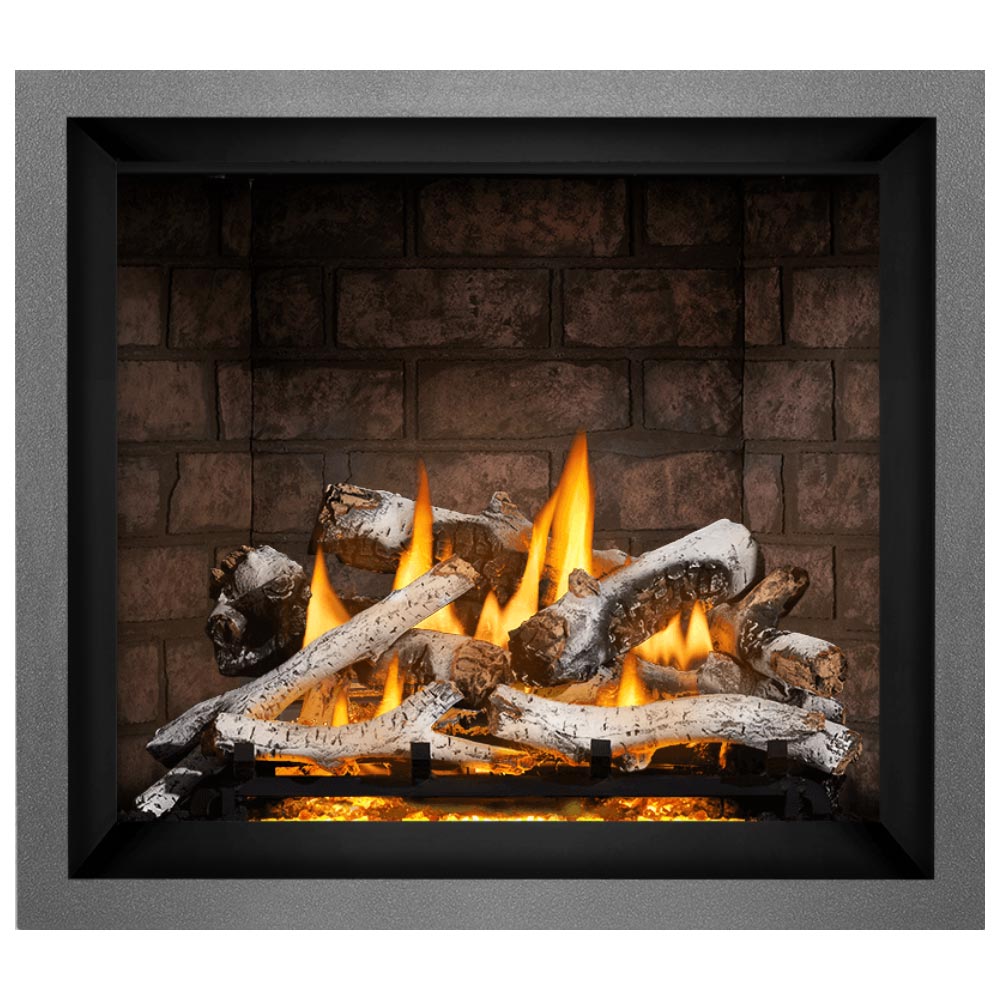 Direct vent gas fireplace with black frame, burning logs in front of brick back panel