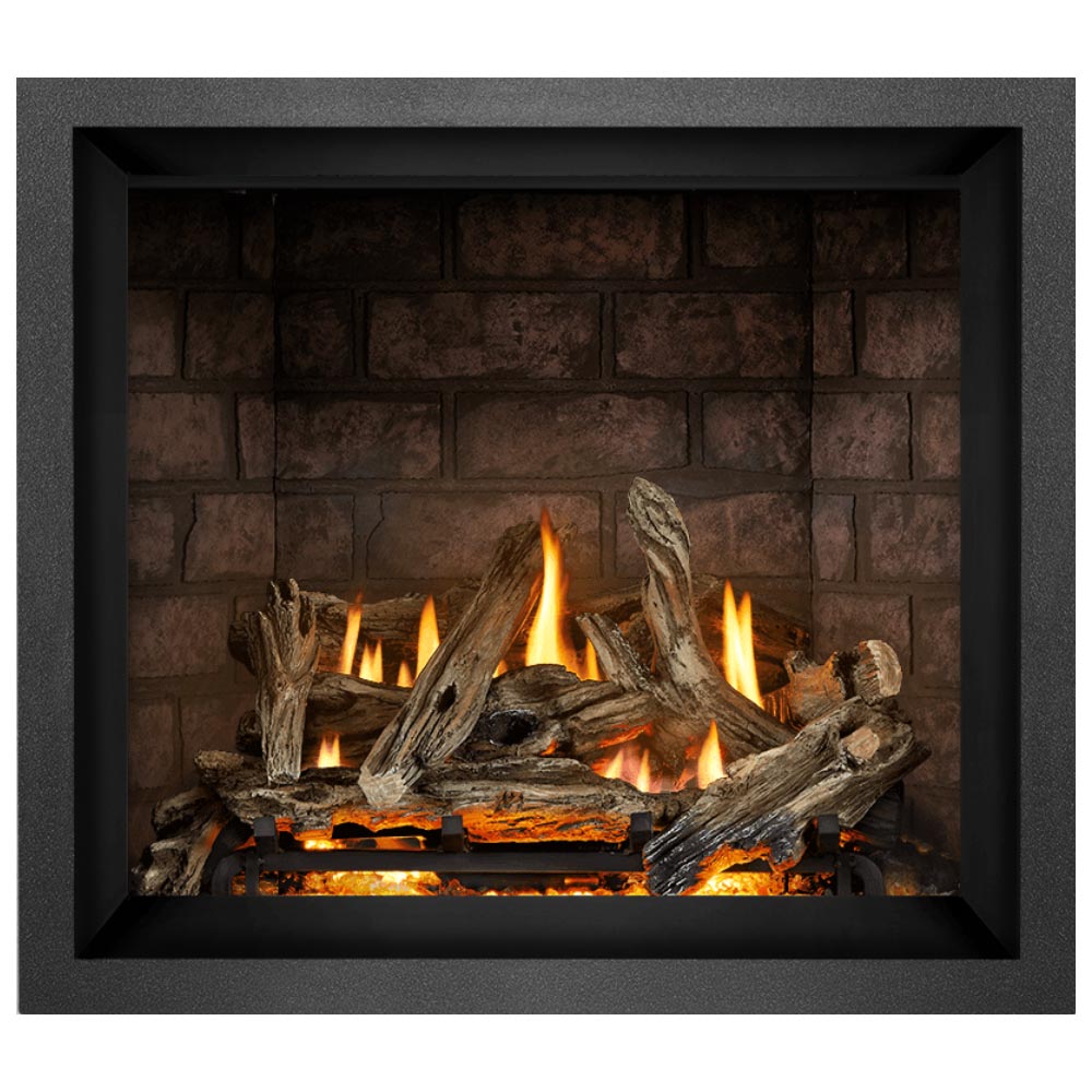 Black direct vent gas fireplace with stacked split logs and orange flames in brick-style firebox
