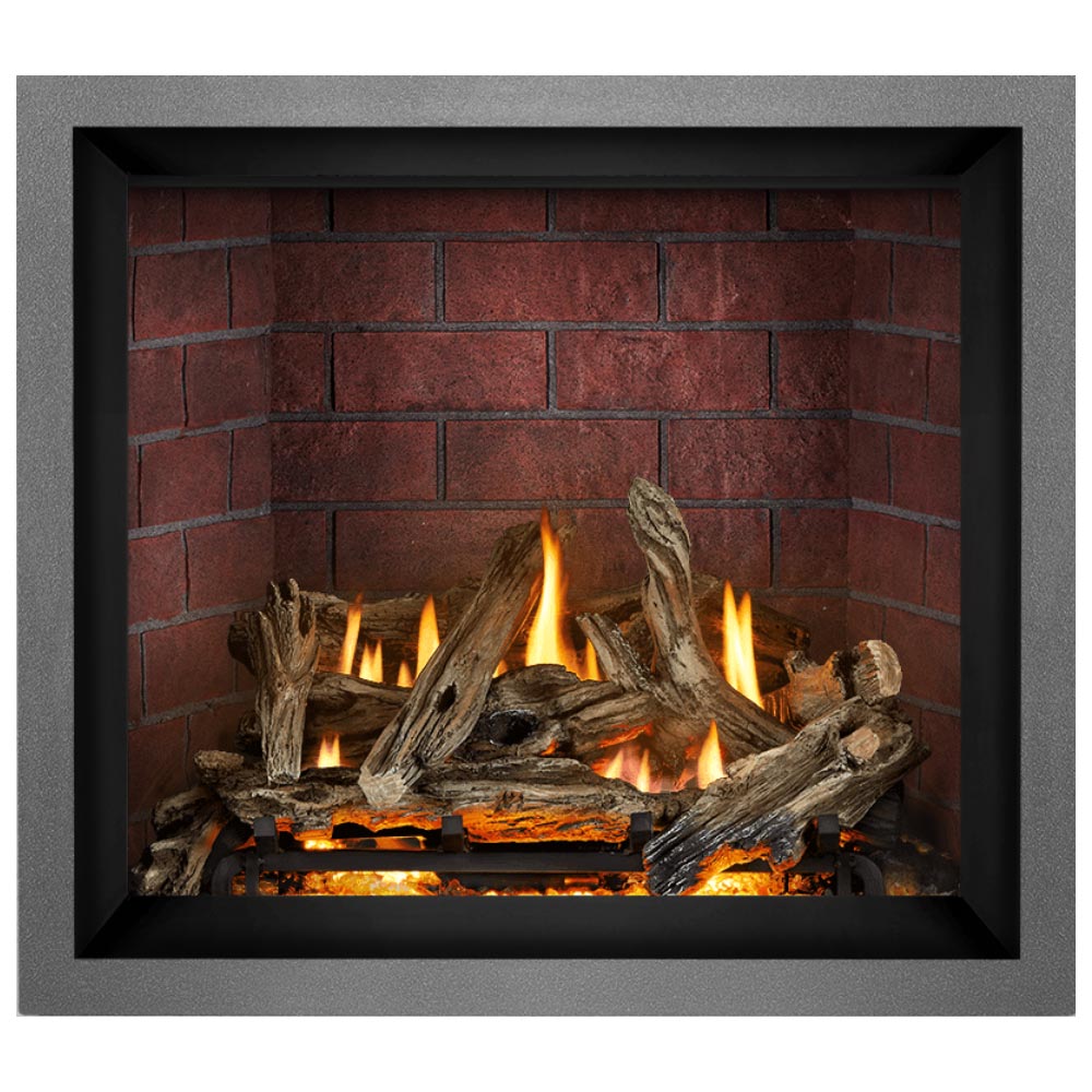 Direct vent gas fireplace showing charred logs with flames and glowing embers inside.