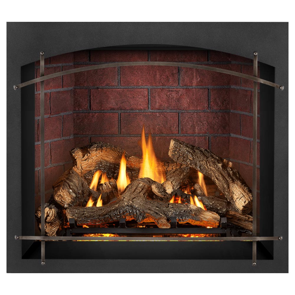 Gas fireplace insert with burning logs, arched metal frame, dark surround, red brick back