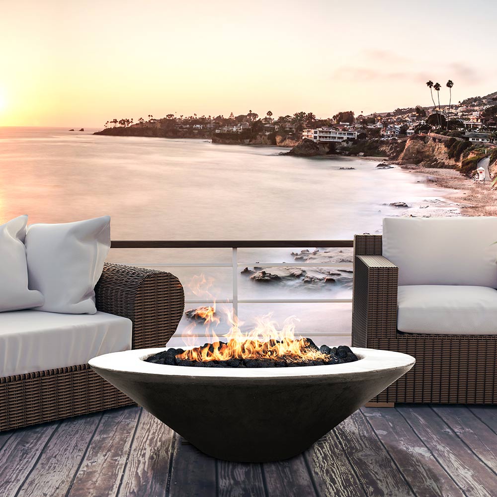 Dark concrete gas fire pit bowl with visible flames and central burner grate
