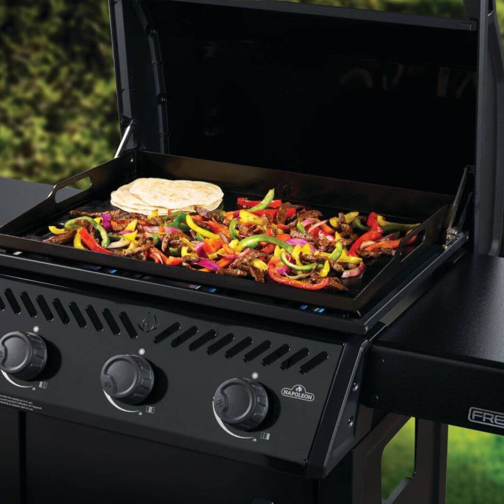 Gas griddle cart with cooking griddle loaded with colorful vegetables